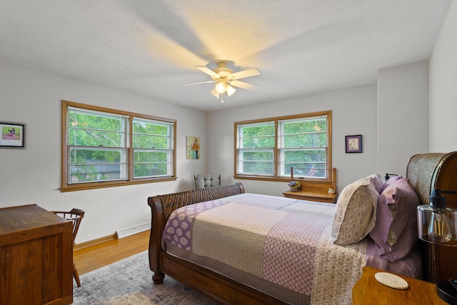 368 Crown Pt, Columbia, MO 65203 - bedroom with multiple windows, wood finished floors, baseboards, and baseboard heating