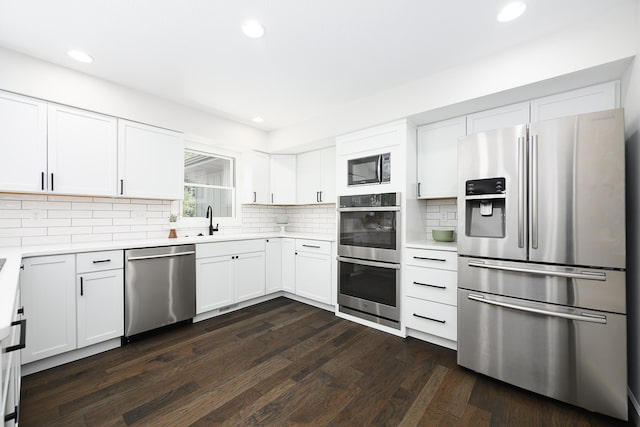 1152 E Bluebird Ln, Columbia, MO 65201 - kitchen featuring stainless steel appliances, recessed lighting, light countertops, dark wood-style flooring, and backsplash