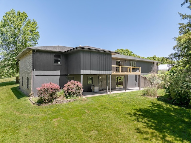 1152 E Bluebird Ln, Columbia, MO 65201 - rear view of house featuring a patio, a lawn, and a deck