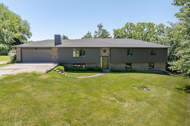 1152 E Bluebird Ln, Columbia, MO 65201 - bi-level home with concrete driveway, an attached garage, a chimney, brick siding, and a front yard