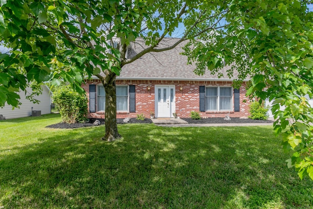 1411 Kinloch Ct, Columbia, MO 65203 - cape cod house featuring roof with shingles, brick siding, a front lawn, and central AC