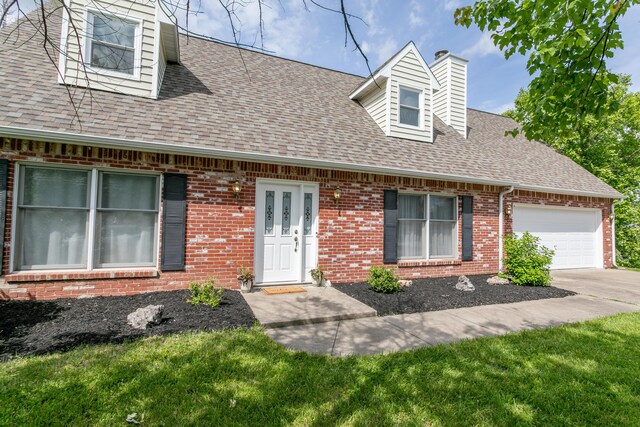 1411 Kinloch Ct, Columbia, MO 65203 - cape cod house featuring a chimney, a shingled roof, brick siding, an attached garage, and driveway
