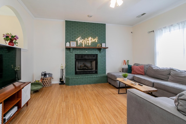 1411 Kinloch Ct, Columbia, MO 65203 - living room with a brick fireplace, wood finished floors, and ornamental molding