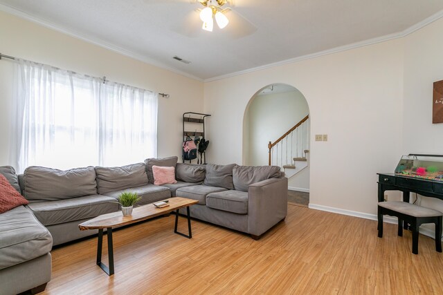 1411 Kinloch Ct, Columbia, MO 65203 - living room with arched walkways, a ceiling fan, light wood-type flooring, ornamental molding, and stairs