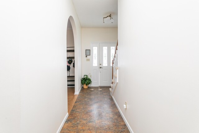 1411 Kinloch Ct, Columbia, MO 65203 - corridor with arched walkways, stone finish flooring, and baseboards