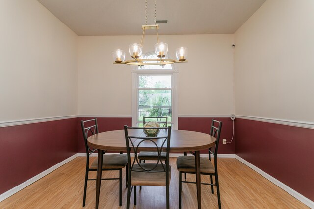 1411 Kinloch Ct, Columbia, MO 65203 - dining space with a chandelier, light wood-style flooring, and baseboards