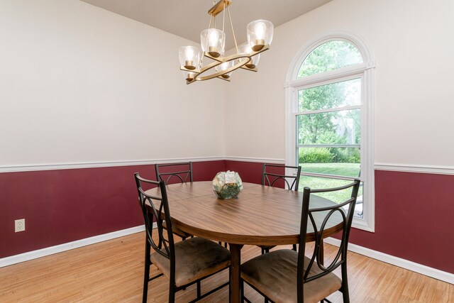 1411 Kinloch Ct, Columbia, MO 65203 - dining space with baseboards, light wood-style flooring, a chandelier, and lofted ceiling