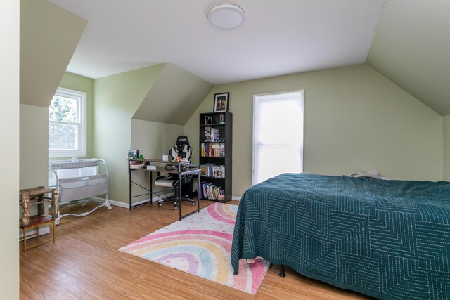 1411 Kinloch Ct, Columbia, MO 65203 - bedroom featuring vaulted ceiling, wood finished floors, and baseboards