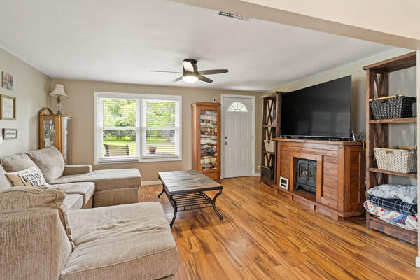 105 W Johnson Ave, Ashland, MO 65010 - living room featuring ceiling fan, wood finished floors, and a fireplace