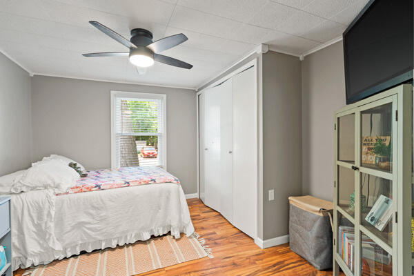 105 W Johnson Ave, Ashland, MO 65010 - bedroom featuring light wood-type flooring, a closet, ornamental molding, a ceiling fan, and baseboards