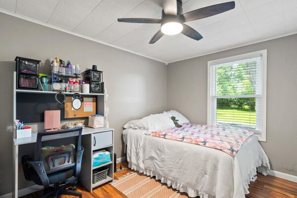 105 W Johnson Ave, Ashland, MO 65010 - bedroom featuring ornamental molding, wood finished floors, a desk, baseboards, and a ceiling fan