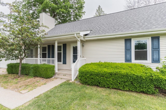 606 Wientz St, Moberly, MO 65270 - view of front of property with a porch, a chimney, roof with shingles, and a front lawn