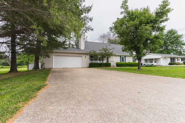 606 Wientz St, Moberly, MO 65270 - single story home featuring asphalt driveway, a front yard, a chimney, roof with shingles, and an attached garage
