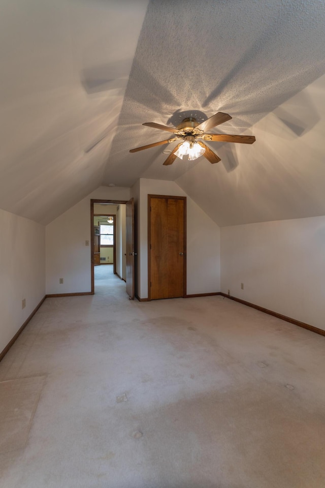 606 Wientz St, Moberly, MO 65270 - bonus room featuring light carpet, lofted ceiling, baseboards, and a ceiling fan
