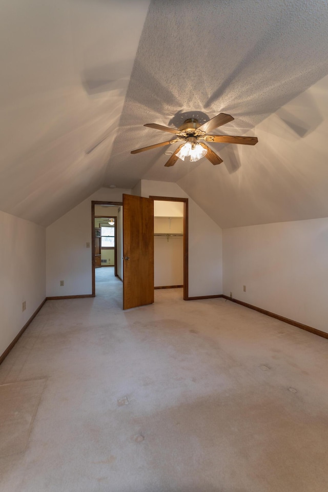 606 Wientz St, Moberly, MO 65270 - additional living space featuring light carpet, vaulted ceiling, ceiling fan, and baseboards