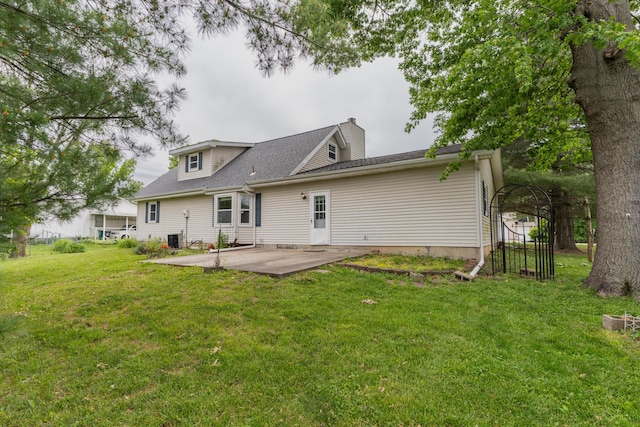 606 Wientz St, Moberly, MO 65270 - rear view of property featuring a patio area, a yard, and a chimney
