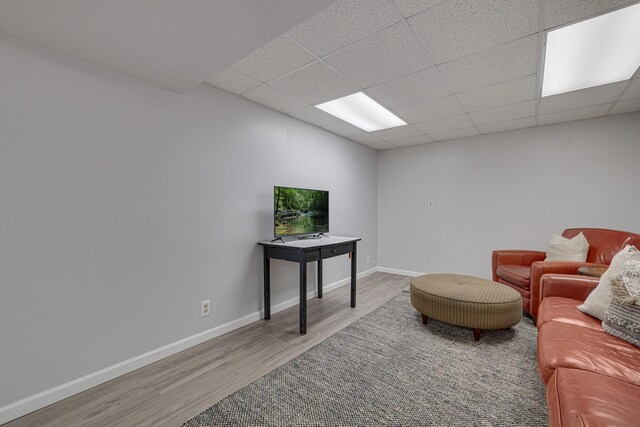 109 N Linnwood Dr, Linn, MO 65051 - living area with wood finished floors, a drop ceiling, and baseboards