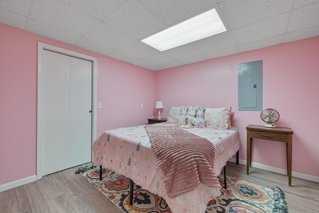 109 N Linnwood Dr, Linn, MO 65051 - bedroom featuring electric panel, wood finished floors, a drop ceiling, and baseboards