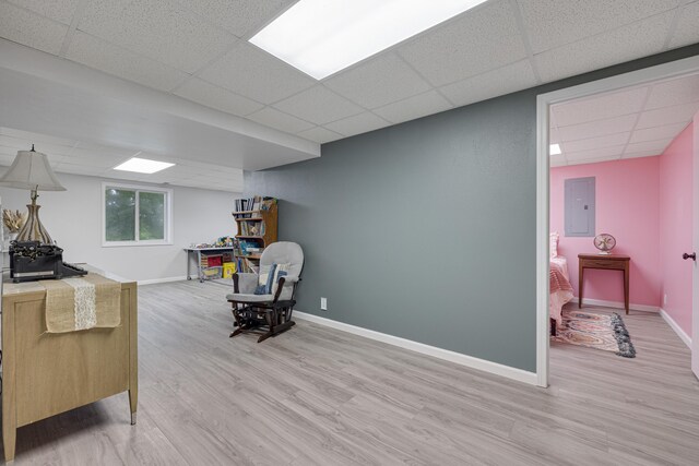 109 N Linnwood Dr, Linn, MO 65051 - living area with a paneled ceiling, light wood-type flooring, baseboards, and electric panel