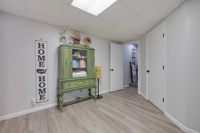 109 N Linnwood Dr, Linn, MO 65051 - unfurnished room featuring a drop ceiling, light wood-type flooring, and baseboards