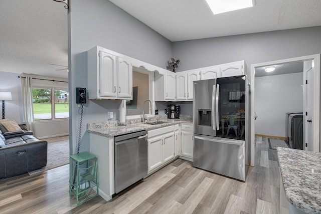 109 N Linnwood Dr, Linn, MO 65051 - kitchen featuring stainless steel appliances, a sink, and white cabinets