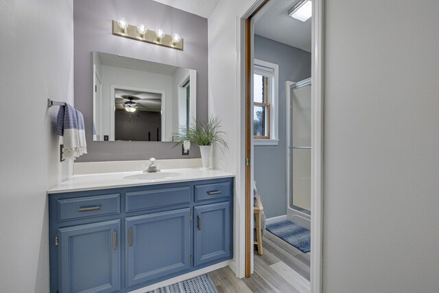 109 N Linnwood Dr, Linn, MO 65051 - full bath with wood finished floors, vanity, a shower stall, and ceiling fan