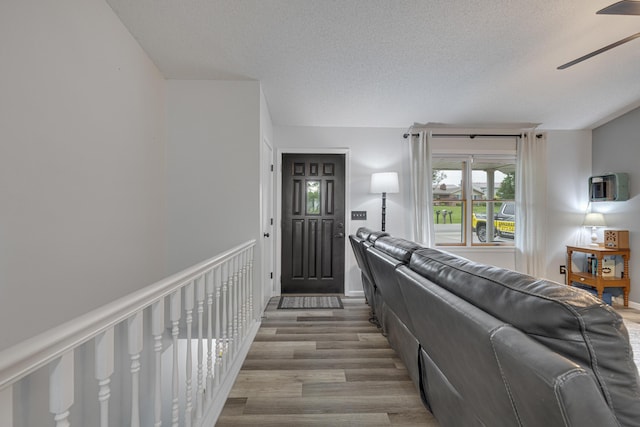109 N Linnwood Dr, Linn, MO 65051 - living area featuring ceiling fan, wood finished floors, a textured ceiling, and baseboards