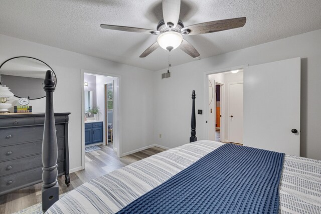 109 N Linnwood Dr, Linn, MO 65051 - bedroom featuring light wood-style flooring, a textured ceiling, ceiling fan, baseboards, and connected bathroom