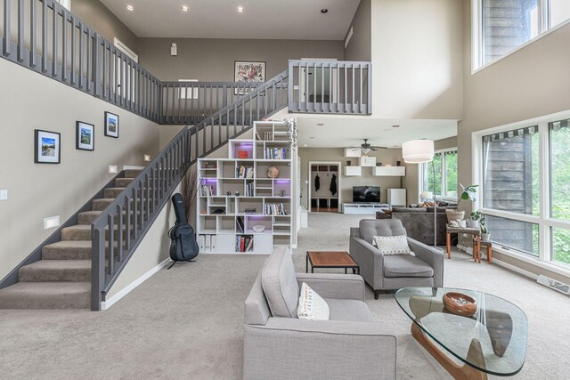 2416 Cimarron Dr, Columbia, MO 65203 - living area featuring carpet floors, a high ceiling, plenty of natural light, stairway, and recessed lighting
