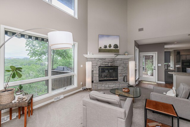 2416 Cimarron Dr, Columbia, MO 65203 - living room featuring a towering ceiling, a fireplace, baseboards, and carpet flooring