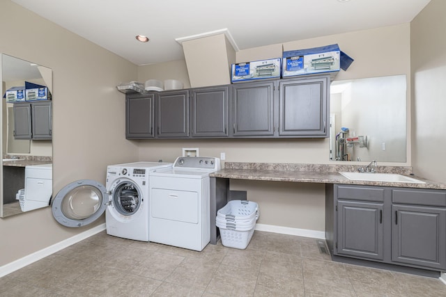 2416 Cimarron Dr, Columbia, MO 65203 - washroom featuring cabinet space, independent washer and dryer, baseboards, and light tile patterned floors