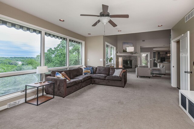 2416 Cimarron Dr, Columbia, MO 65203 - carpeted living room with a stone fireplace, a ceiling fan, and recessed lighting