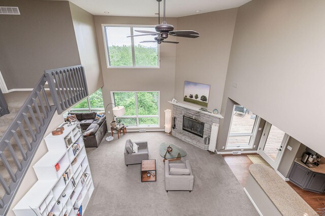 2416 Cimarron Dr, Columbia, MO 65203 - living area with a high ceiling, a fireplace, a ceiling fan, stairs, and wood finished floors