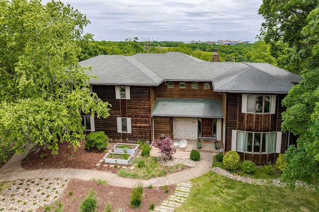2416 Cimarron Dr, Columbia, MO 65203 - view of front of house featuring a garden, a chimney, and roof with shingles