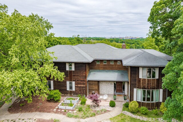 2416 Cimarron Dr, Columbia, MO 65203 - view of front of property featuring a garden, a chimney, and a shingled roof