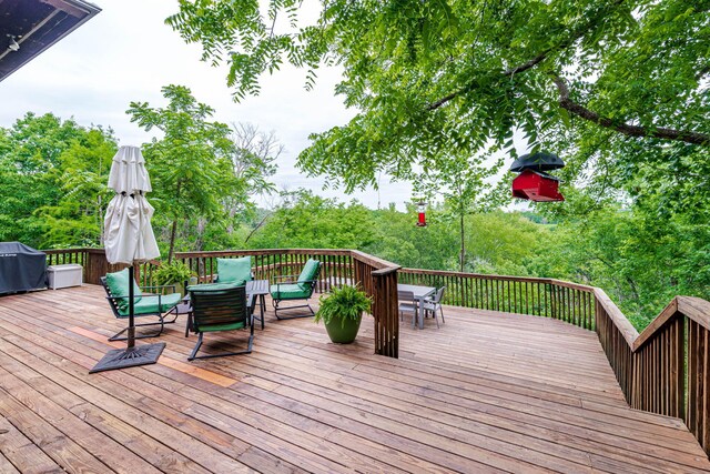 2416 Cimarron Dr, Columbia, MO 65203 - wooden deck featuring grilling area, outdoor dining area, and an outdoor living space
