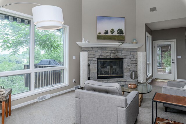 2416 Cimarron Dr, Columbia, MO 65203 - living area with carpet, baseboards, a stone fireplace, and a towering ceiling