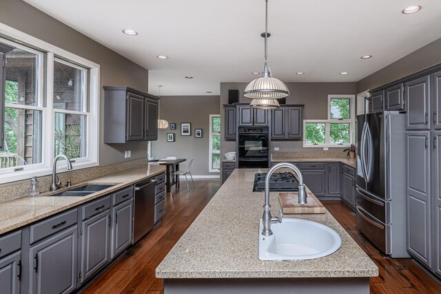 2416 Cimarron Dr, Columbia, MO 65203 - kitchen with a sink, appliances with stainless steel finishes, an island with sink, gray cabinetry, and recessed lighting