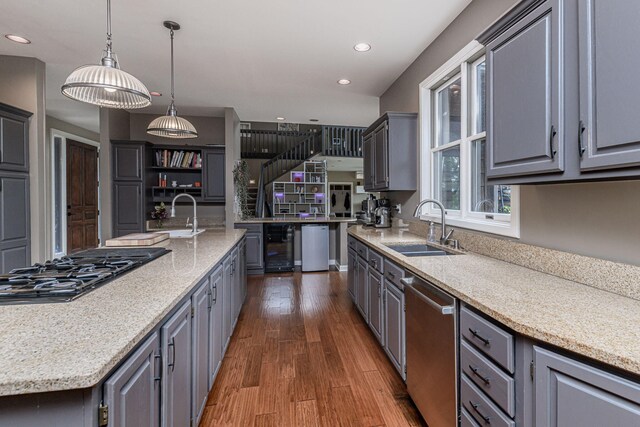 2416 Cimarron Dr, Columbia, MO 65203 - kitchen featuring stainless steel dishwasher, a sink, black gas stovetop, gray cabinetry, and recessed lighting