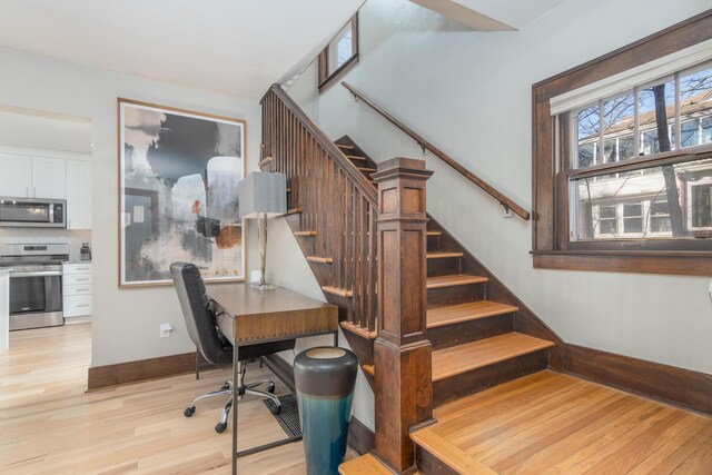 303 S Glenwood Ave, Columbia, MO 65203 - stairway featuring wood finished floors and baseboards