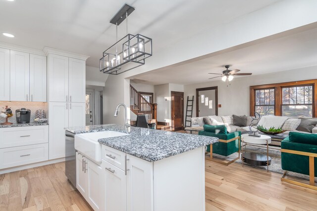 303 S Glenwood Ave, Columbia, MO 65203 - kitchen with stainless steel dishwasher, light wood-type flooring, open floor plan, white cabinetry, and recessed lighting