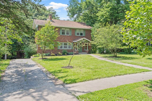 303 S Glenwood Ave, Columbia, MO 65203 - colonial house with brick siding, a front yard, a chimney, and asphalt driveway