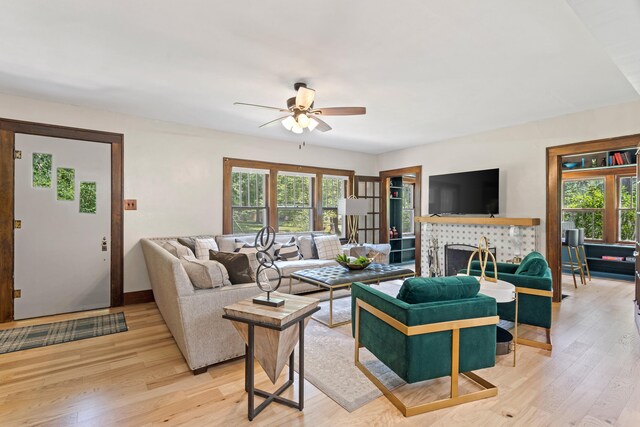303 S Glenwood Ave, Columbia, MO 65203 - living room featuring light wood-style floors, ceiling fan, and a tile fireplace