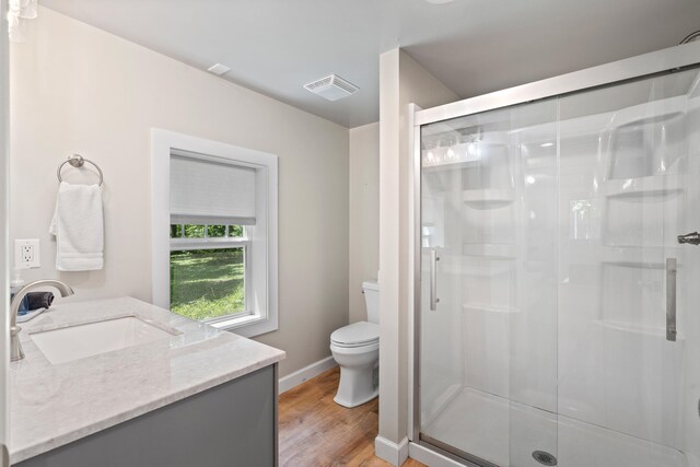 303 S Glenwood Ave, Columbia, MO 65203 - bathroom with a stall shower, vanity, and wood finished floors