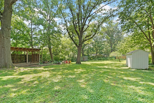 303 S Glenwood Ave, Columbia, MO 65203 - view of green lawn with a storage unit and view of wooded area