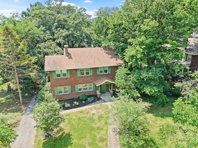 303 S Glenwood Ave, Columbia, MO 65203 - view of front of home with driveway, brick siding, a chimney, and covered porch