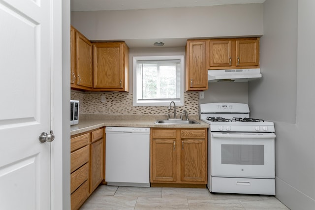 500 W Sexton Rd, Columbia, MO 65203 - kitchen with white appliances, under cabinet range hood, a sink, decorative backsplash, and light countertops