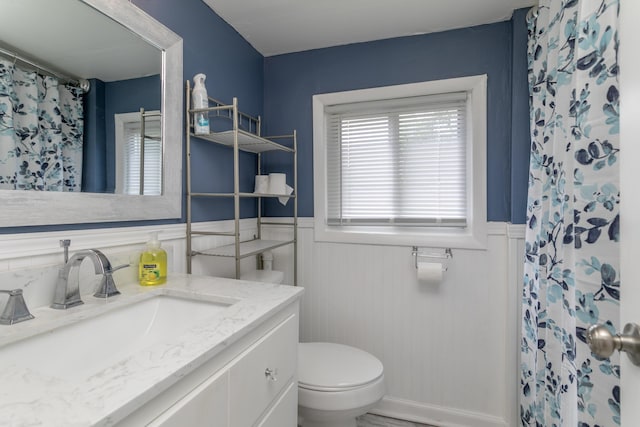 500 W Sexton Rd, Columbia, MO 65203 - bathroom featuring a wainscoted wall, vanity, toilet, and a shower with curtain