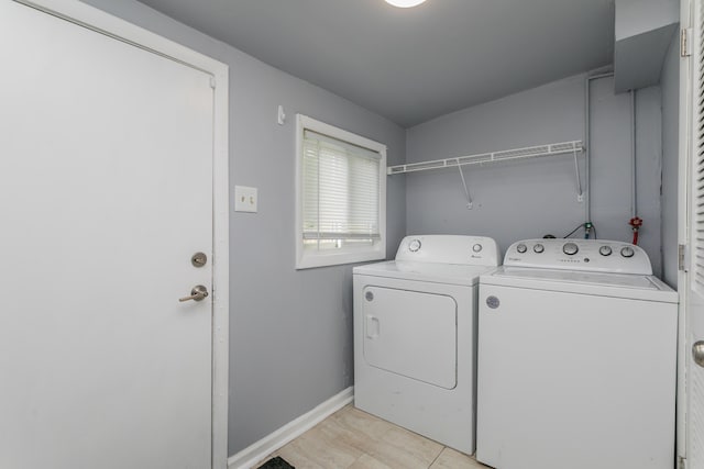 500 W Sexton Rd, Columbia, MO 65203 - laundry area featuring washer and clothes dryer, baseboards, and light tile patterned floors
