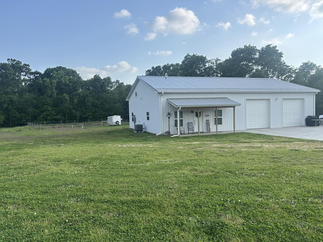 11630 N Varnon School Rd, Hallsville, MO 65255 - view of front of home with a front yard, metal roof, central AC unit, and a detached garage